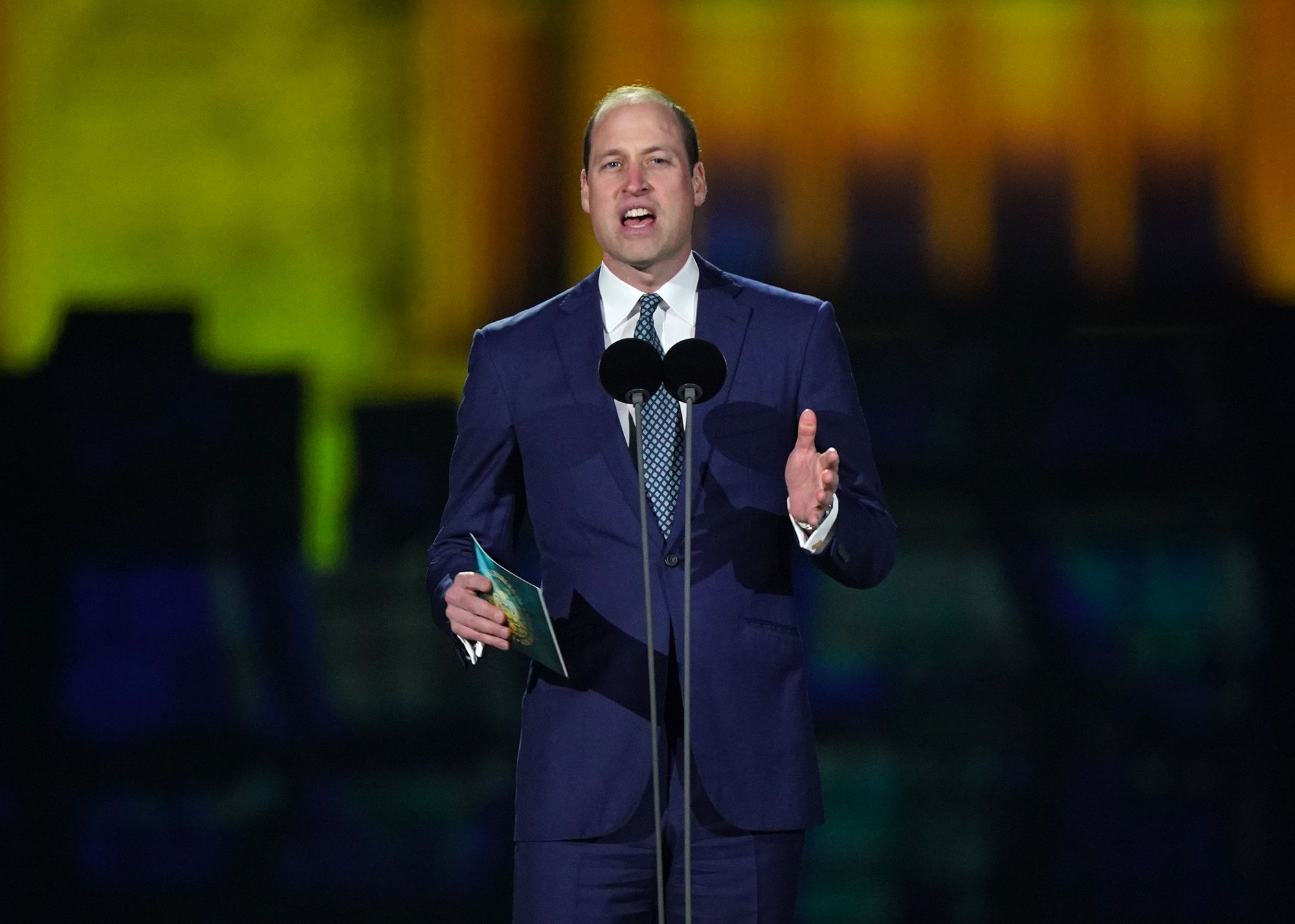 Prince William speaks on stage.