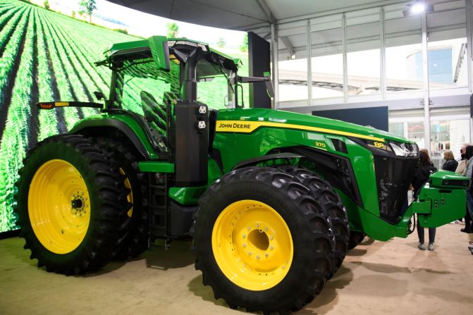 Autonomous tractors are being-touted as a labor-saving innovation. The John Deere 8R fully autonomous tractor is pictured ahead of the Consumer Electronics Show (CES) in Las Vegas, 2022. It features GPS and 360-degree cameras that allow it to be controlled from a smartphone.