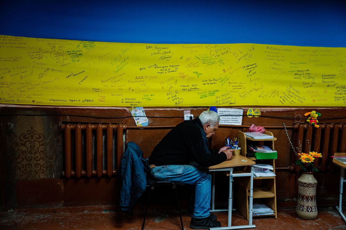 A local resident checks his phone in a volunteer-run shelter in the town of Orikhiv, in the Zaporizhzhia region, on May 7.