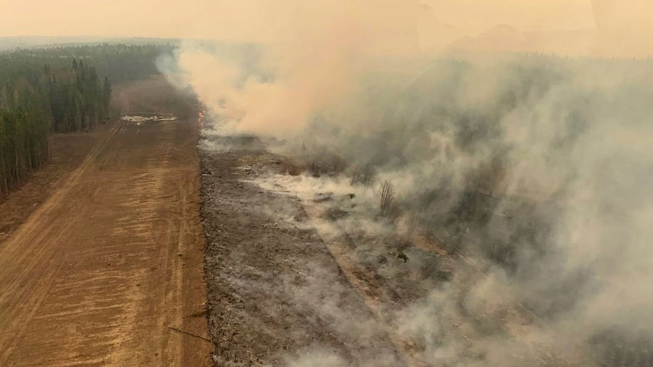 A burned section of forest smolders in the area near Edson, Alberta, on Saturday.