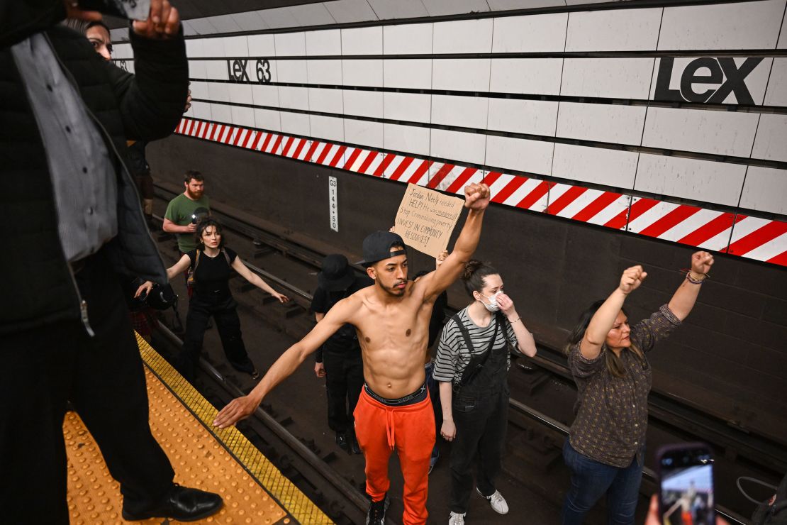 NEW YORK, NEW YORK - MAY 06: Protesters sit on train tracks at the Lexington Ave/63rd Street subway station during a 