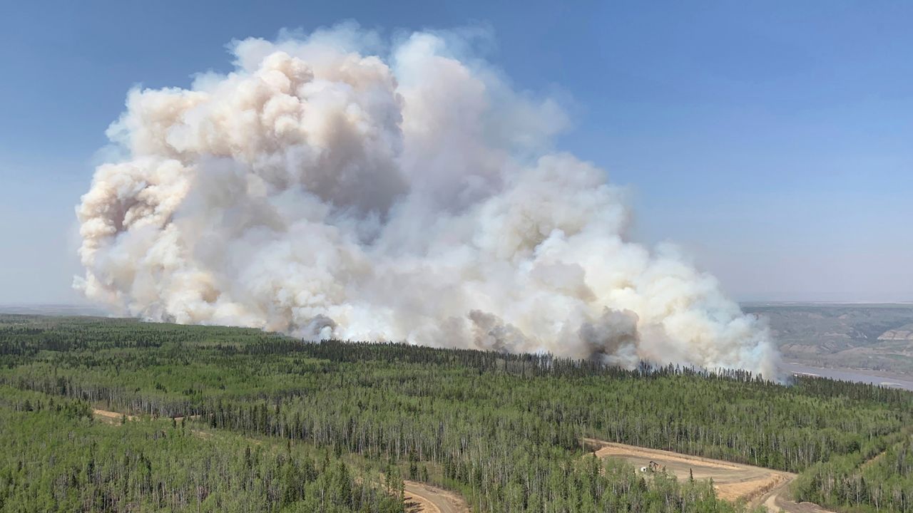A wildfire burns a section of forest in the Grande Prairie district of Alberta on Saturday.
