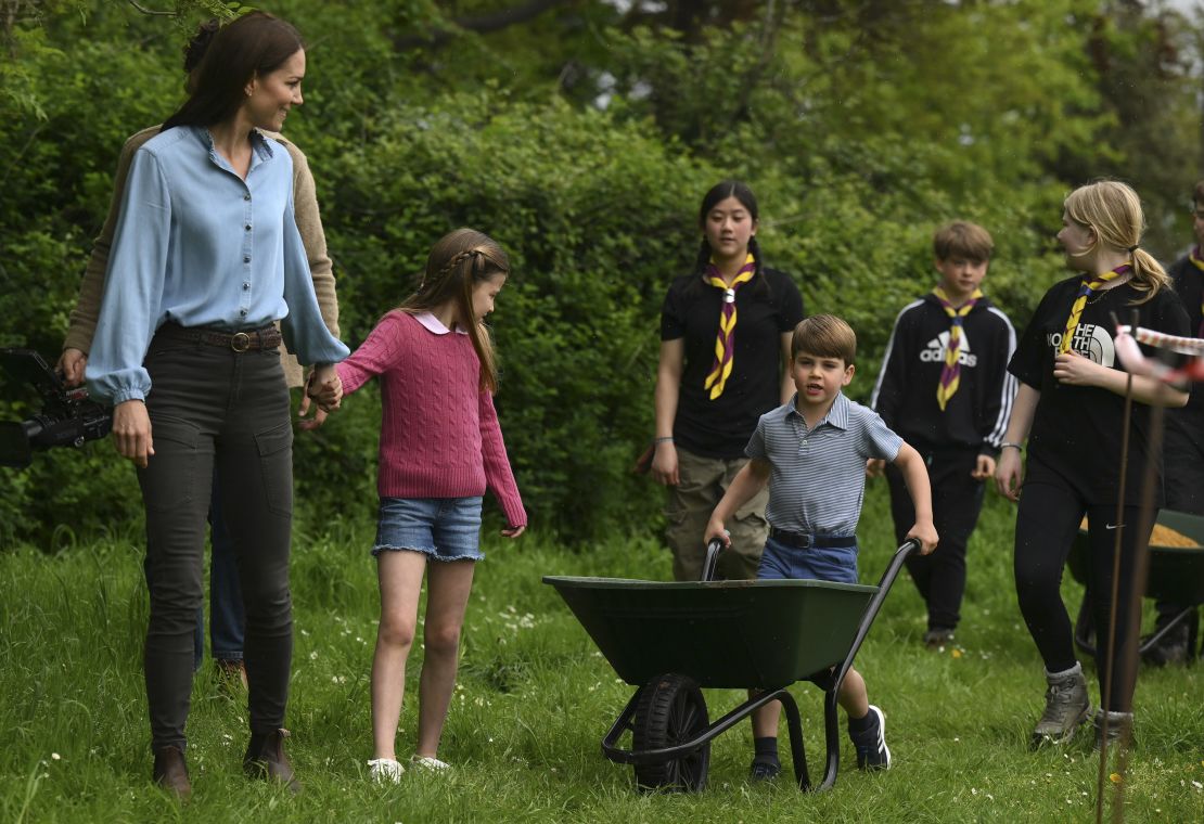 Prince Louis pushed a loaded wheelbarrow while his mother and sister -- the Princess of Wales and Princess Charlotte -- watched on.