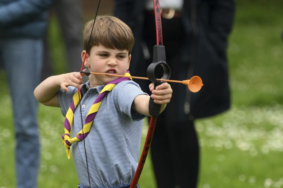 Prince Louis tries his hand at archery while taking part in the Big Help Out.