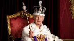 In this photo made available by Buckingham Palace on Monday, May 8, 2023, Britain's King Charles III poses for a photo in full regalia in the Throne Room, London. The King is wearing the Robe of Estate, the Imperial State Crown and is holding the Sovereign's Orb and Sovereign's Sceptre with Cross. He is seated on one of a pair of 1902 throne chairs that were made for the future King George V and Queen Mary for use at the Coronation of King Edward VII. (Hugo Burnand/Royal Household 2023 via AP)