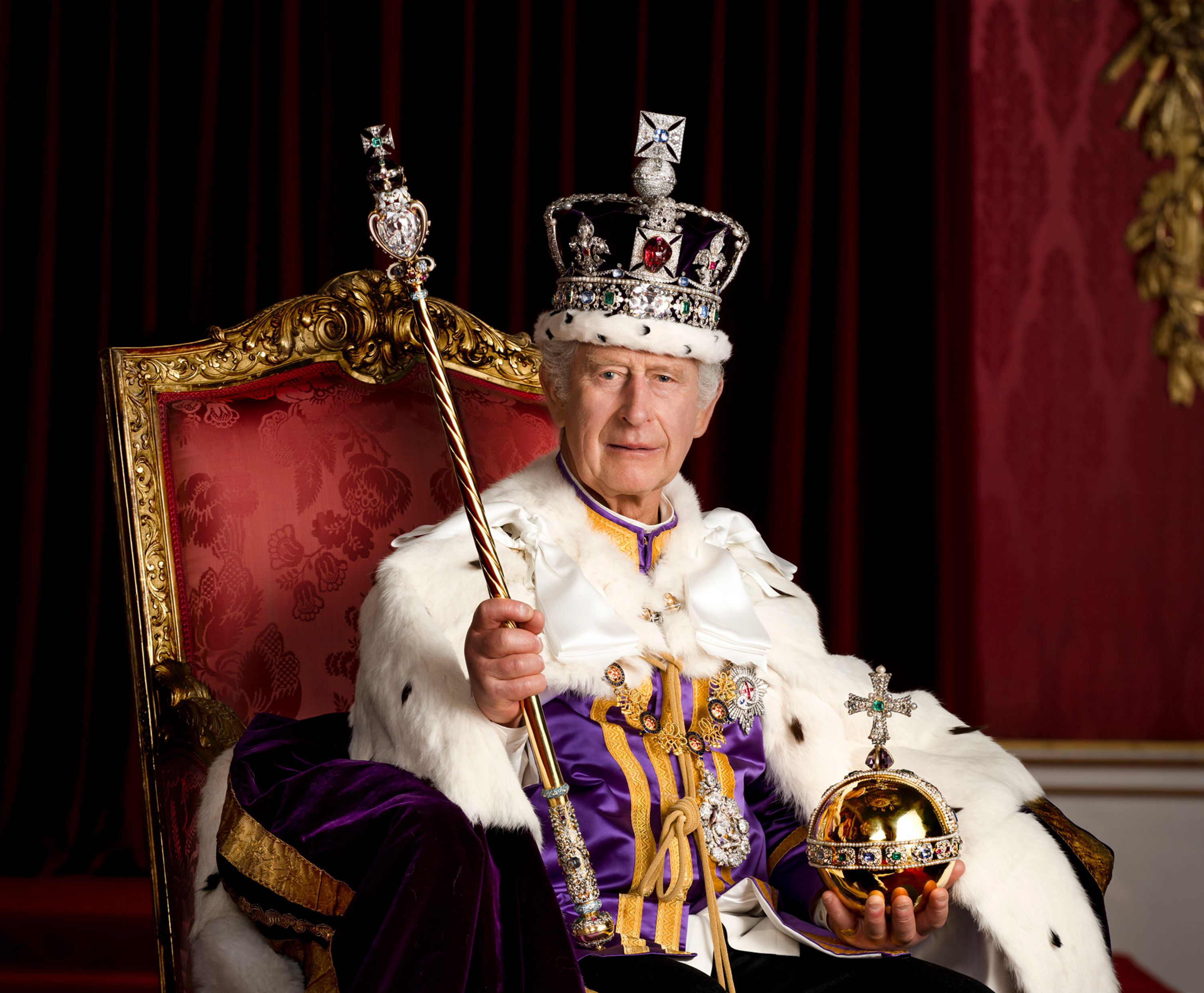 Britain's King Charles III <a href="index.php?page=&url=https%3A%2F%2Fwww.cnn.com%2F2023%2F05%2F08%2Fuk%2Fcoronation-official-portraits-intl-gbr-ckc%2Findex.html" target="_blank">poses for a portrait</a> in Buckingham Palace's Throne Room dressed in full regalia. He is wearing the Robe of Estate and the Imperial State Crown while holding the Sovereign's Orb and the Sovereign's Sceptre with Cross.
