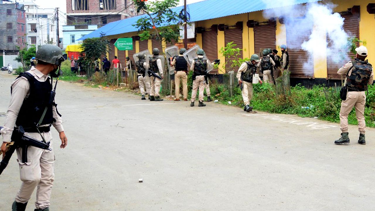 In this picture taken on May 4, 2023, security personnel fire tear gas whilst the Meitei community tribals protest to demand inclusion under the Scheduled Tribe category, in Imphal the capital of India's Manipur state. 