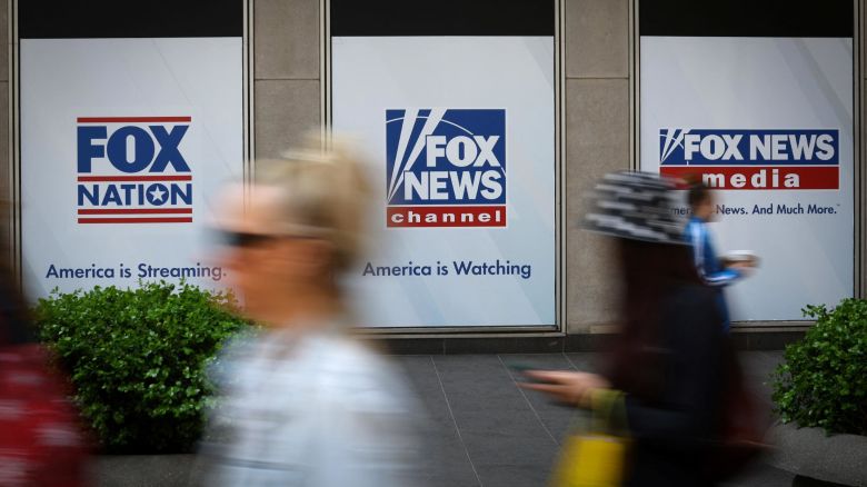 People walk past Fox News posters on the exterior of the News Corporation and Fox News headquarters building in Manhattan in New York City, New York, U.S., April 24, 2023. REUTERS/Mike Segar
