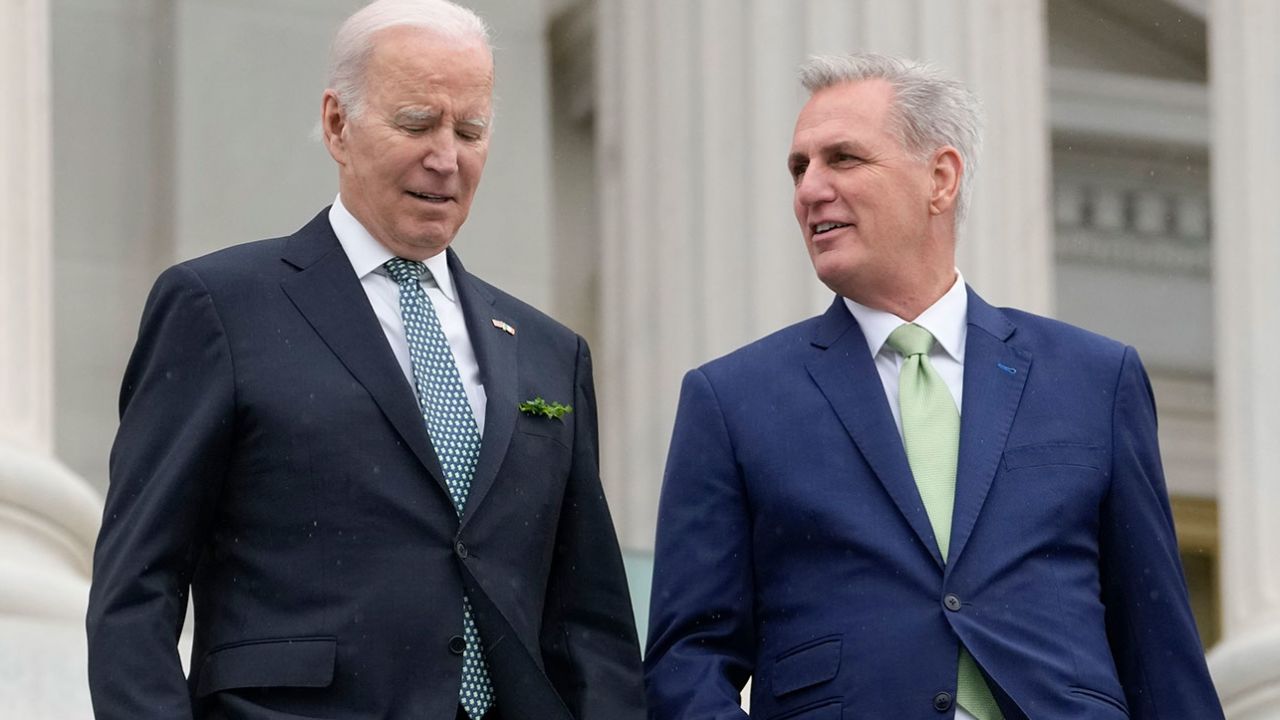 President Joe Biden talks with House Speaker Kevin McCarthy as they leave an annual St. Patrick's Day luncheon at the Capitol on March 17, 2023. 