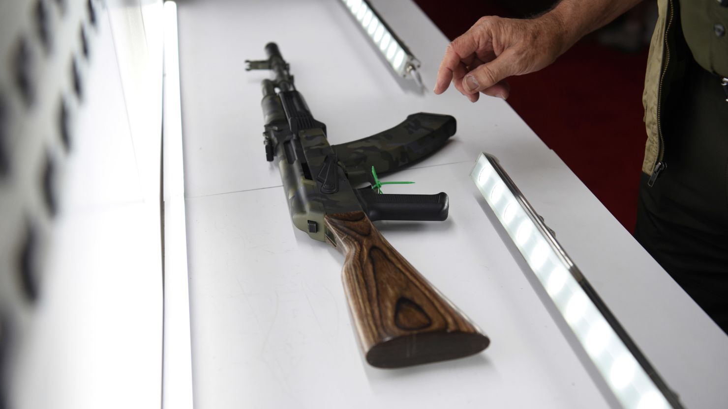 An attendee looks at a gun on display at the National Rifle Association annual convention in Houston, Texas, on May 28, 2022.