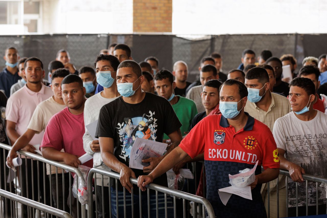 Migrants wait in line at a processing center in Brownsville on May 4.