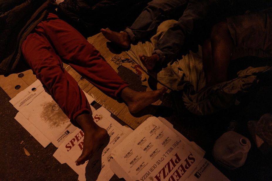 Migrants camp out in an alley behind the Sacred Heart Church in downtown El Paso on April 30.