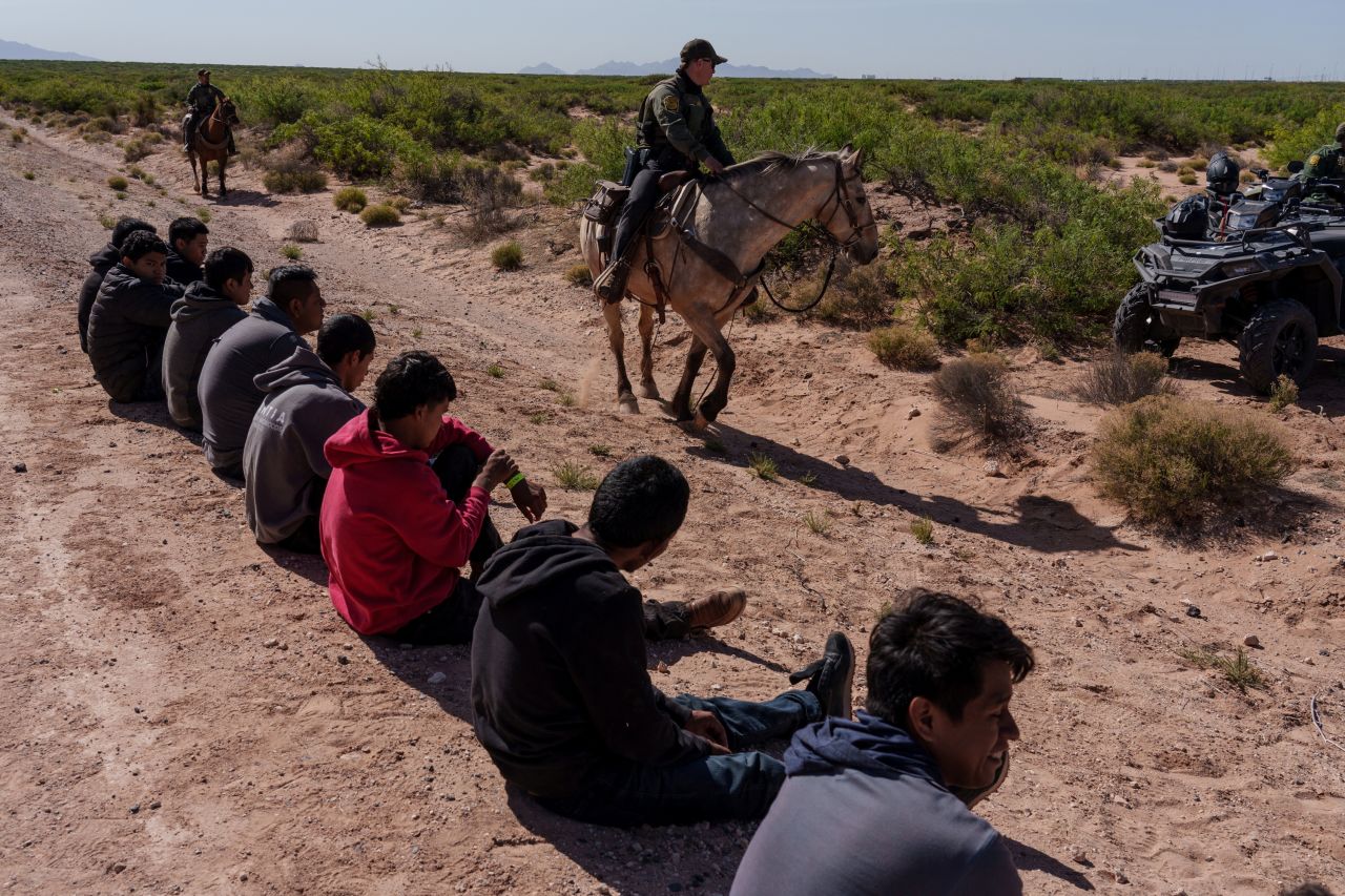 Migrants wait to be processed by US Border Patrol agents in Santa Teresa, New Mexico, on April 26.