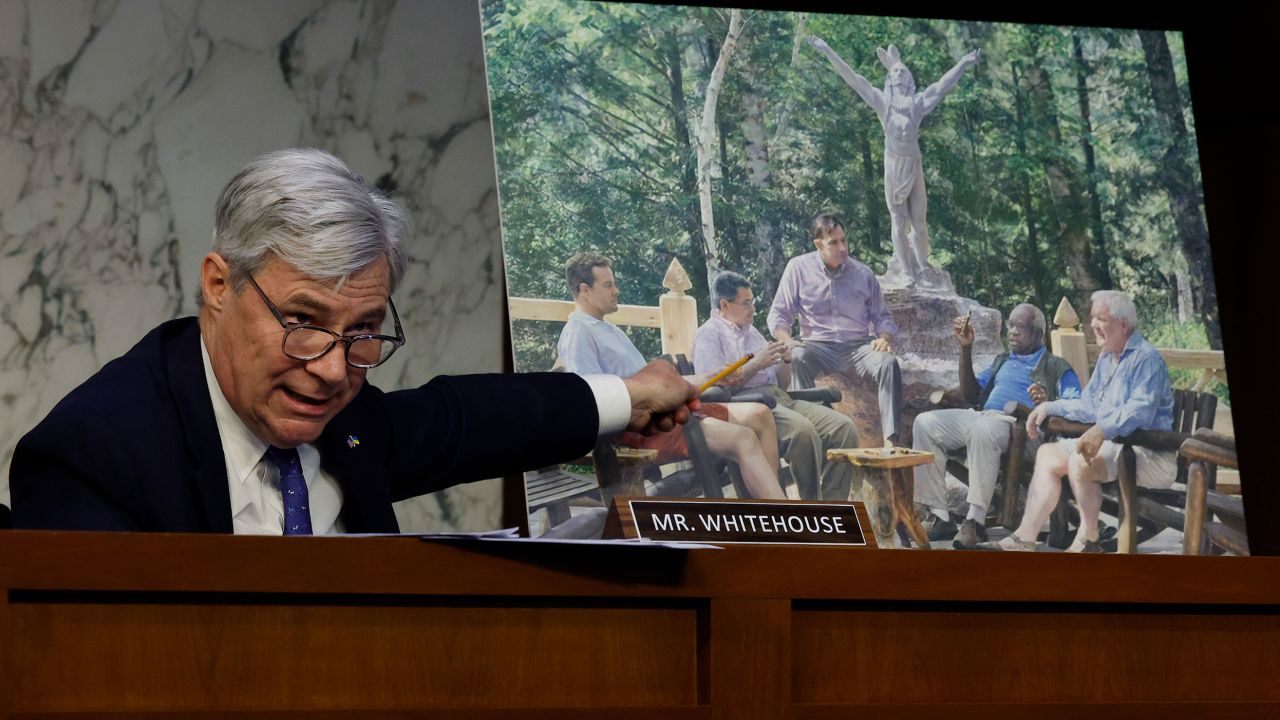 Senate Judiciary Committee member Sen. Sheldon Whitehouse (D-RI) displays a copy of a painting featuring Supreme Court Associate Justice Clarence Thomas alongside other conservative leaders during a hearing on Supreme Court ethics reform in the Hart Senate Office Building on Capitol Hill on May 02, 2023 in Washington, DC.