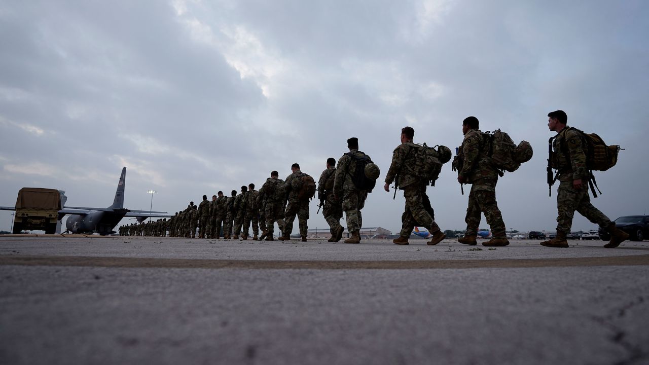 Members of the Texas National Guard board a plane in Austin, Texas, Monday as they are deployed to the Texas-Mexico.