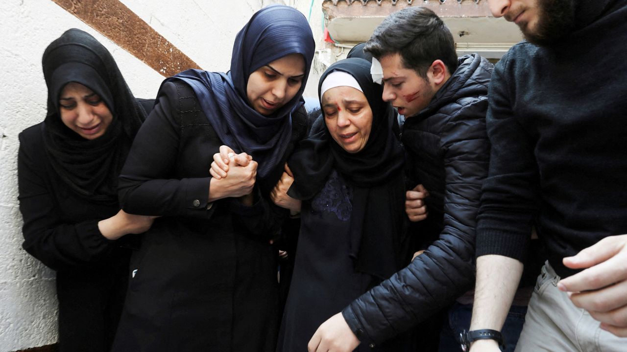 The wife and son of senior Palestinian Islamic Jihad commander Tareq Izzeldeen, who was killed in Israeli strike along with two of his children, mourn during his funeral in Gaza City on Tuesday.