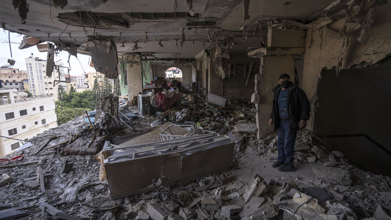 A Palestinian man assesses the destruction of his building by a series of deadly Israeli airstrikes that targeted Islamic Jihad commanders and also killed women and children. 