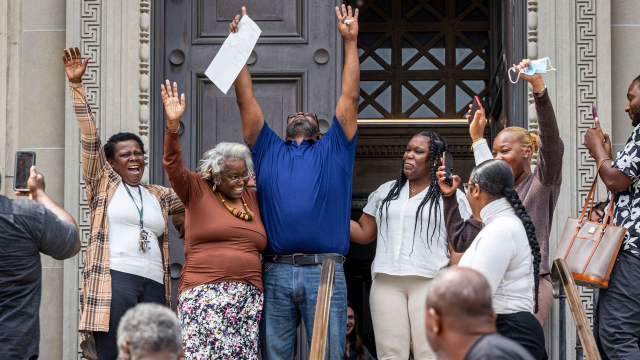 Patrick Brown, center, raises his arms as he walks out a free man on May 8, 2023, in New Orleans after decades in jail.
