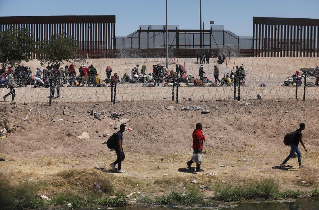 Migrants camp on the banks of the Rio Grande as they wait to be processed by the Border Patrol El Paso Sector, Texas, after crossing from Ciudad Juarez, Mexico on May 8, 2023. 