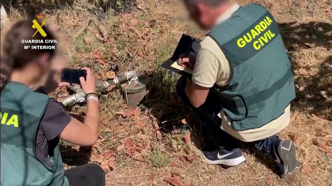 Spanish police officers document illegal water pipes in Malaga province, Spain in this screen grab from an undated handout video.