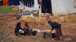 Women cook in the mud at a camp for internally displaced persons in the rebel-held northwestern province of Idlib, Syria, on March 19.
