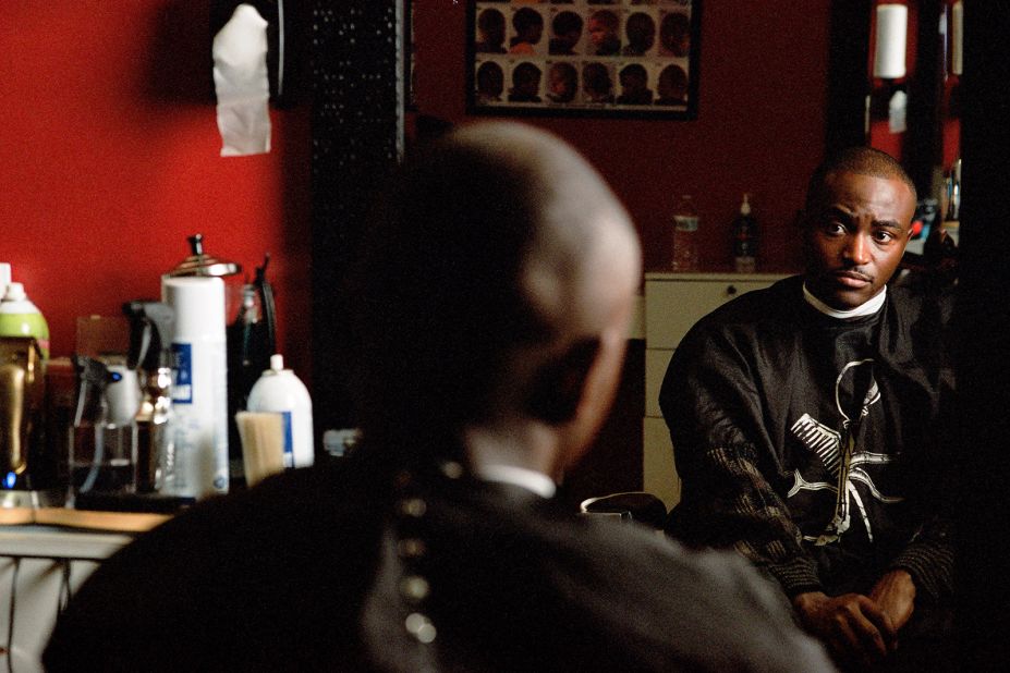 Hakeem, a participant in the "Sowing Rice with Salt" series, pictured at a barbershop. Scroll through the gallery to see more images from the project.