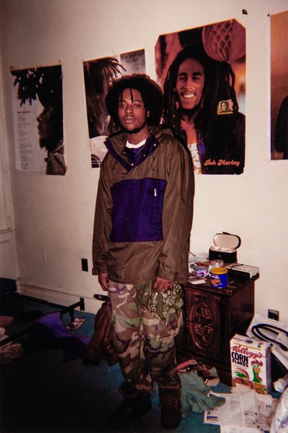 Akil's father, pictured in a similar stance and setting — but with posters of reggae legend Bob Marley.