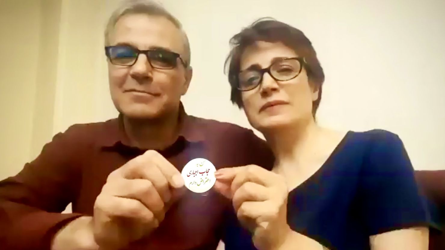 Iranian human rights lawyer Nasrin Sotoudeh and husband Reza Khandan hold up a protest button which reads: 'I Oppose the Mandatory Hijab."