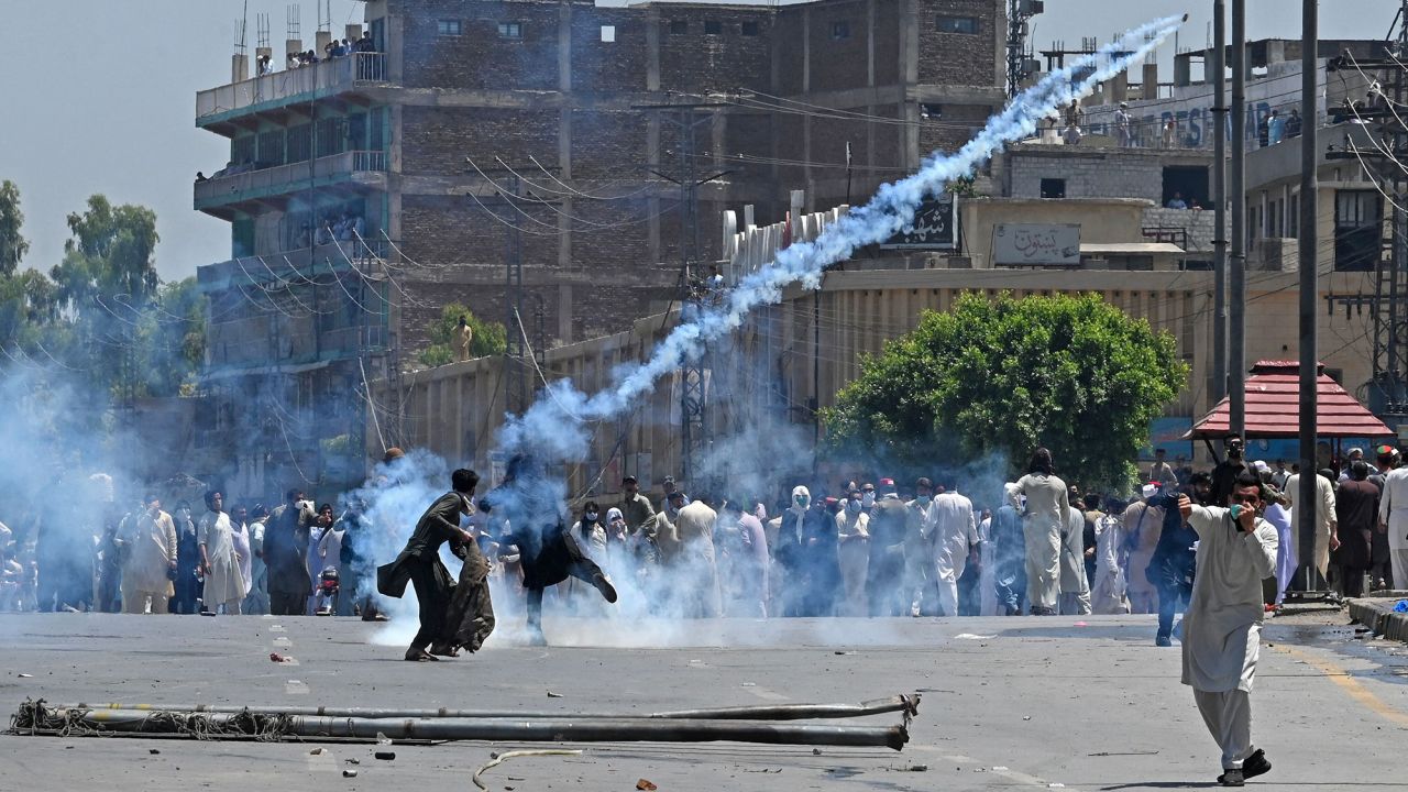 Pakistan Tehreek-e-Insaf (PTI) supporters clash with police during a protest against the arrest of former prime minister Imran Khan in Peshawar on May 10, 2023. 