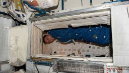 NASA astronaut and Expedition 68 Flight Engineer Josh Cassada is pictured bundled up in his crew quarters aboard the International Space Station.
