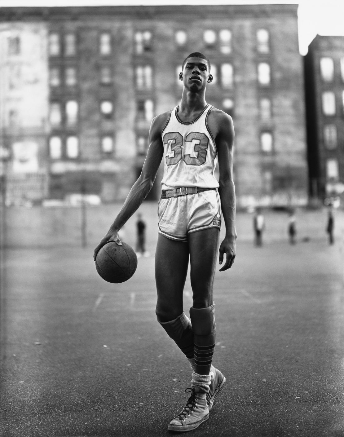"Avedon's 1963 photograph of Lew Alcindor, the star center of Power Memorial Academy in New York City — long before he changed his name to Kareem Abdul-Jabbar — is a celebration of the human form," documentary filmmaker Ken Burns said. "There's a coolness and natural calm in the composition, from the ease with which he grasps the basketball to the casual crossing of his feet."