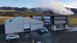 Climeworks factory with it's fans in front of the collector, drawing in ambient air and release it, as largely purified CO2 through ventilators at the back is seen at the Hellisheidi power plant near Reykjavik on October 11, 2021. - Climeworks factory is in ICELAND containers similar to those used in maritime transport are stacked up in pairs, 10 metres (33 feet) high. 
Fans in front of the collector draw in ambient air and release it, largely purified of CO2, through ventilators at the back. (Photo by Halldor KOLBEINS / AFP) (Photo by HALLDOR KOLBEINS/AFP via Getty Images)