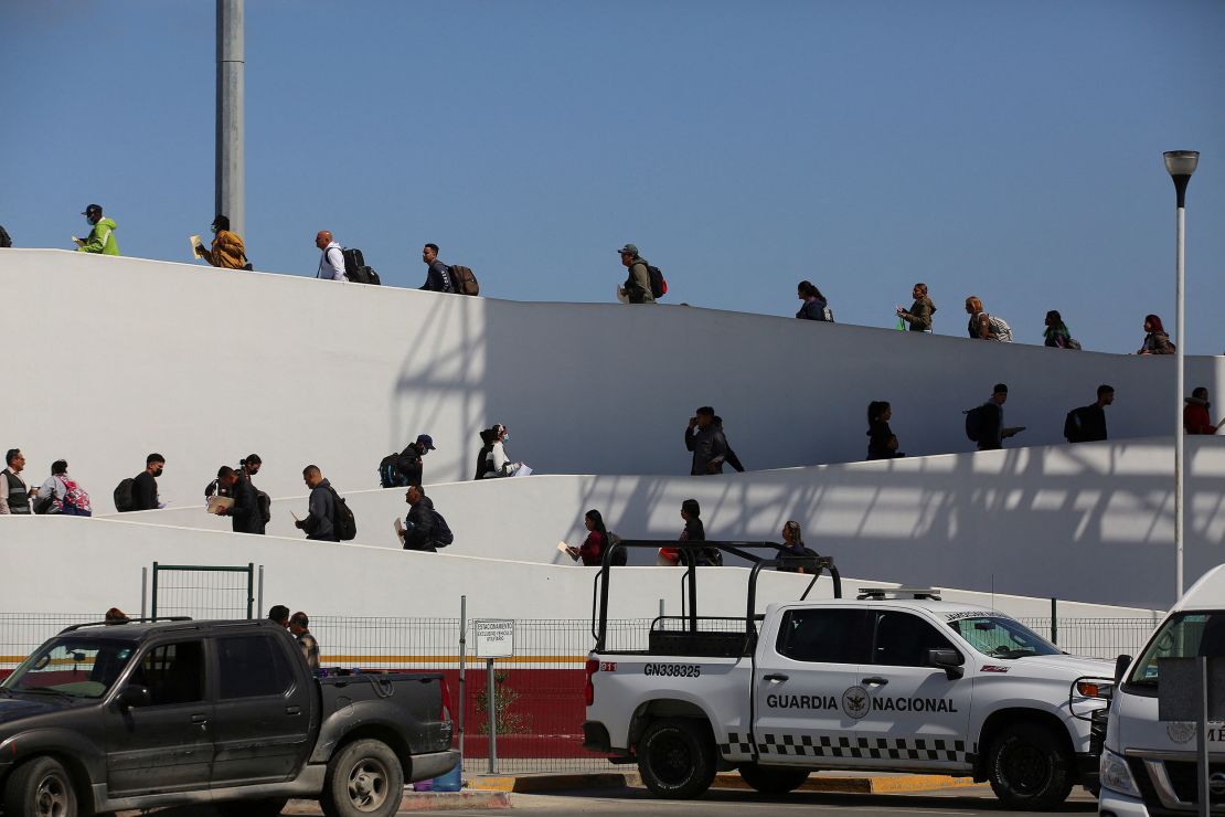 Migrants who requested an appointment for asylum in the United States using the CBP ONE application cross El Chaparral port of entry in Tijuana, Mexico, May 9, 2023.