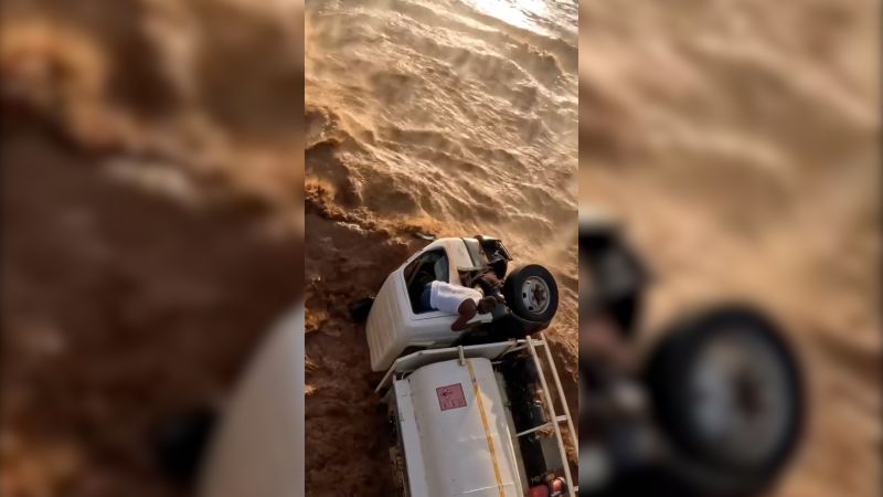 Helicopter flies inches above stranded truck driver to save his life | CNN