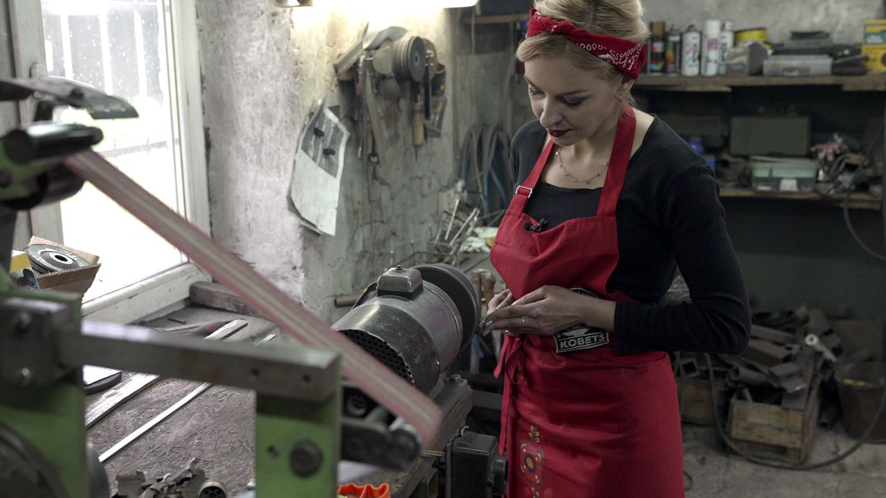 Maria Kobets in the blacksmith forge owned by her husband, Andriy.