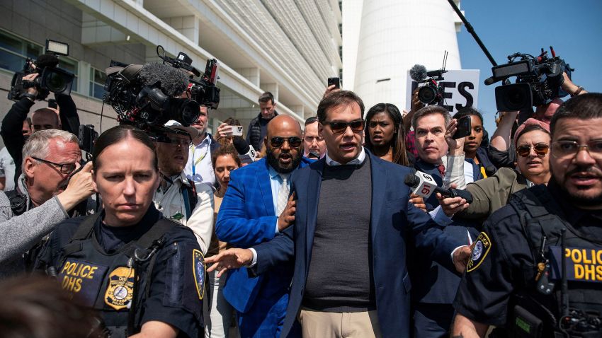 Rep. George Santos is escorted by police as he leaves Central Islip Federal Courthouse in Central Islip, New York, on May 10.