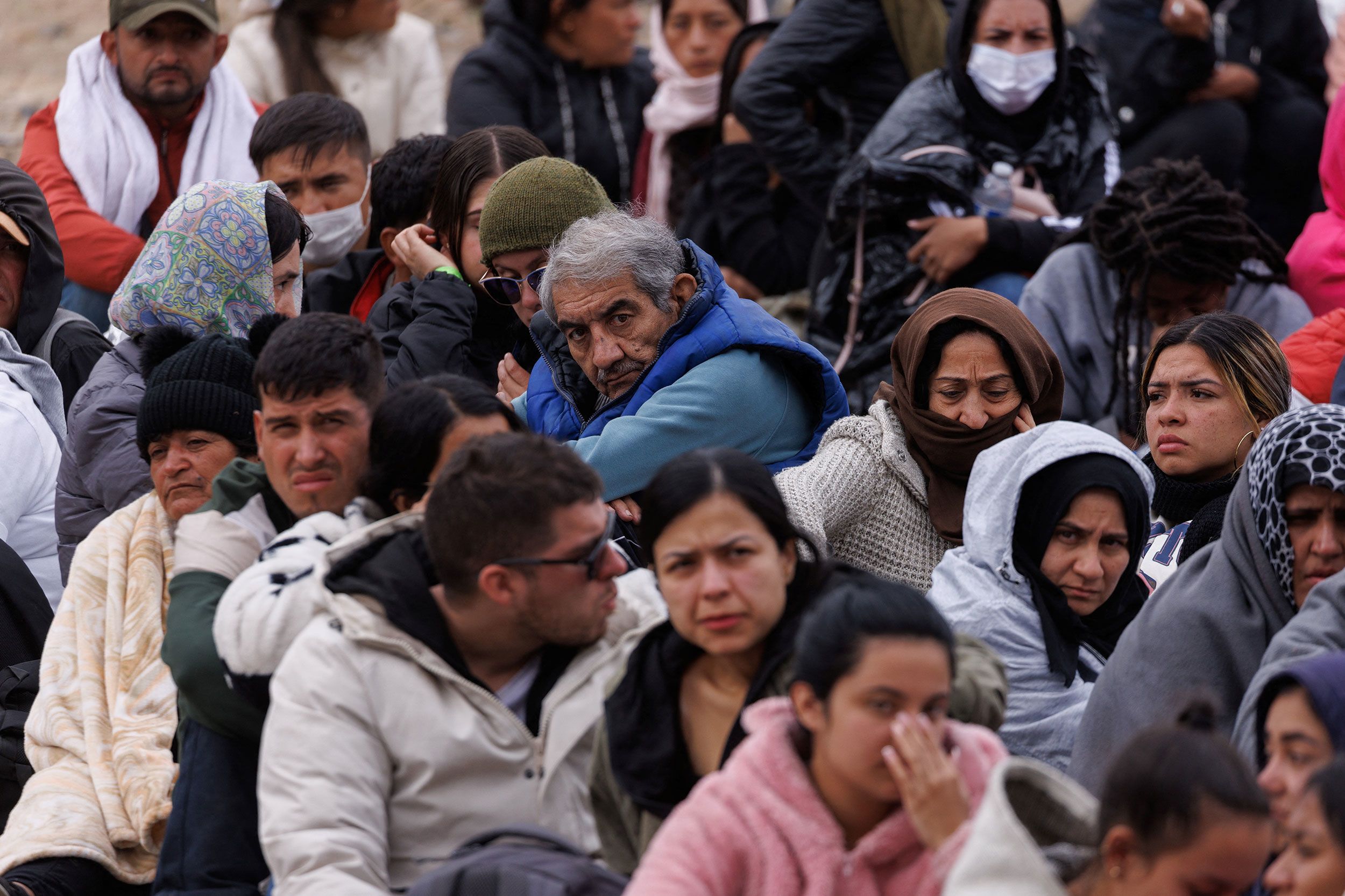 Migrants gather between primary and secondary border fences near San Diego on May 10.