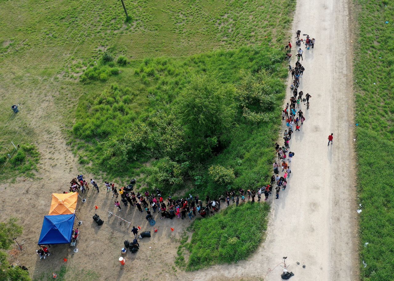 Migrants stand in line as they wait to be processed by US Border Patrol agents in Brownsville on May 10.