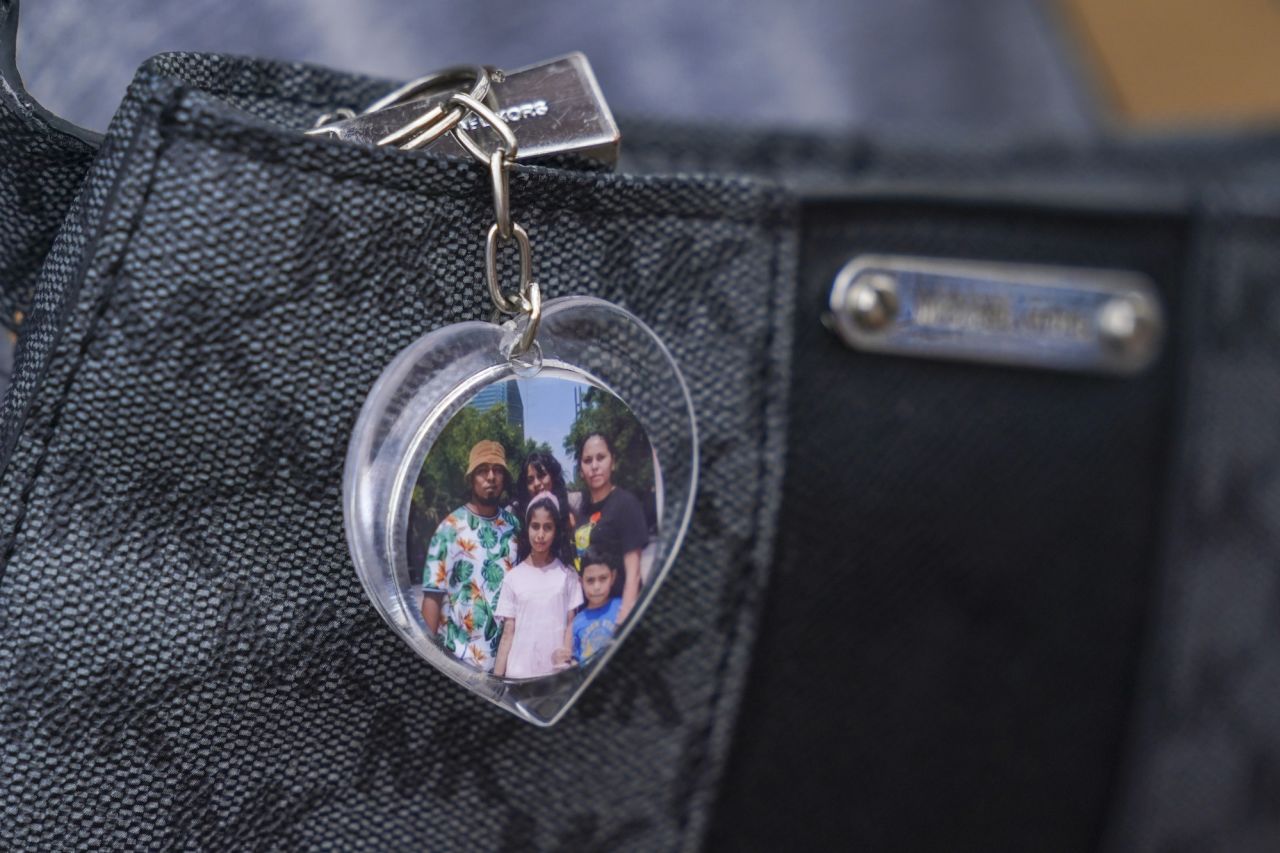 A heart-shaped keychain with a photo of Salvadoran migrant Danilo Ruiz and his family hangs from a handbag at a makeshift shelter in Reynosa, Mexico, on Tuesday, May 9.