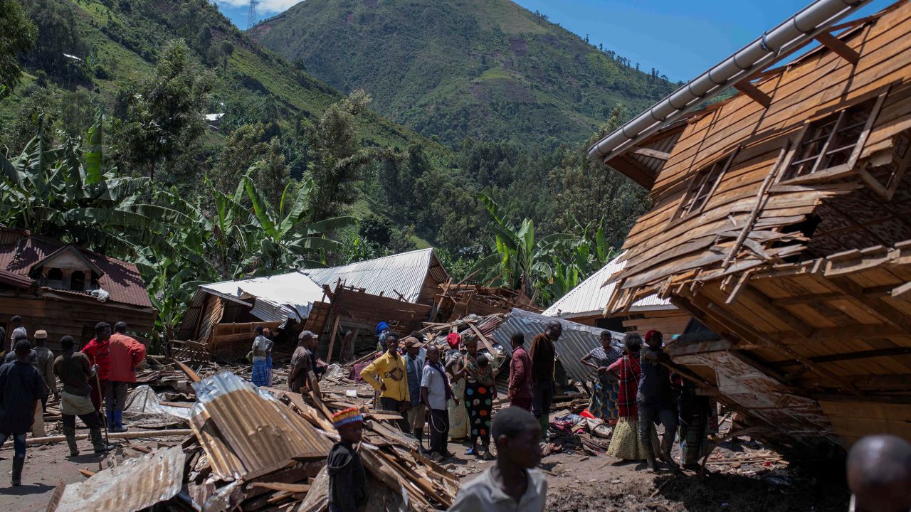 Congolese civilians gather after the death of their family members following rains that destroyed buildings and forced aid workers to gather mud-clad corpses into piles in the village of Nyamukubi, Kalehe territory in South Kivu province of the Democratic Republic of Congo May 6, 2023. 