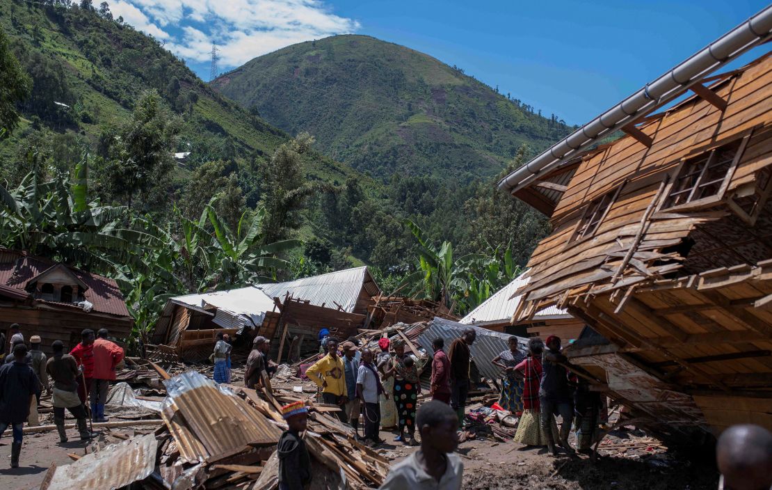 Congolese civilians gather after the death of their family members following rains that destroyed buildings and forced aid workers to gather mud-clad corpses into piles in the village of Nyamukubi, Kalehe territory in South Kivu province of the Democratic Republic of Congo May 6, 2023. 