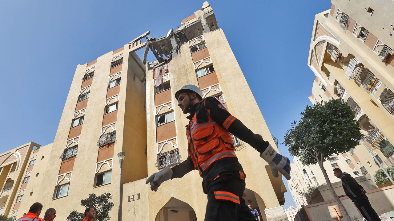 A civil defence worker walks past the building of an Islamic Jihad military leader, which was destroyed by an Israeli bombardment in Khan Yunis on Thursday.