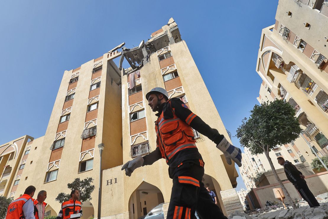 A civil defence worker walks past the building of an Islamic Jihad military leader, which was destroyed by an Israeli bombardment in Khan Yunis on Thursday.