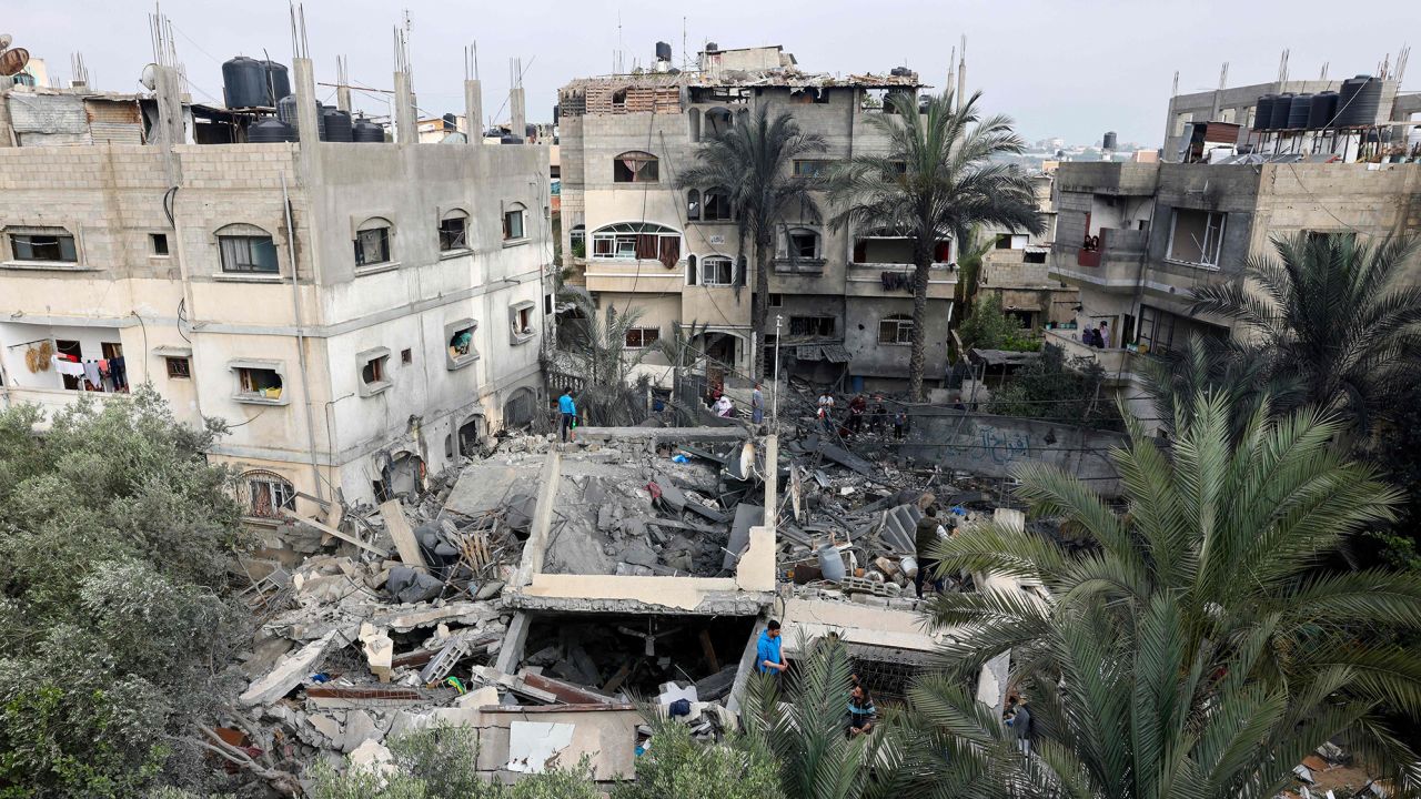 Palestinians inspect the rubble of a building, following an Israeli airstrike in Beit Lahia in Gaza on Thursday.