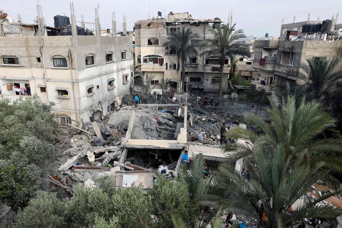 Palestinians inspect the rubble of a building, following an Israeli airstrike in Beit Lahia in Gaza on Thursday.