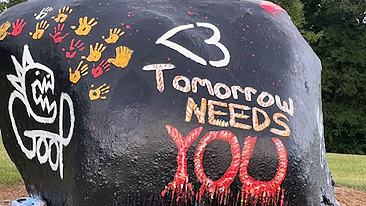 Gavin Guffey's friends spray-painted a rock at his favorite skate park with images of a dinosaur, the symbol <3 and his nickname, Goop.