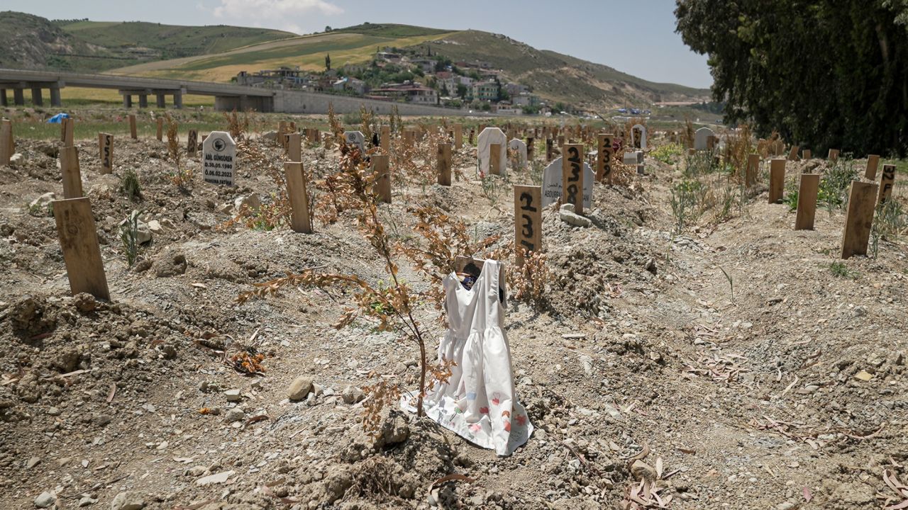 Thousands of people are still unaccounted for from Turkey's earthquake. Sometimes gravediggers will place belongings of the deceased on an unmarked grave to provide a clue for loved ones searching for them. In Narlıca cemetery, the wooden plank on grave number 236 is draped with a child's white dress.