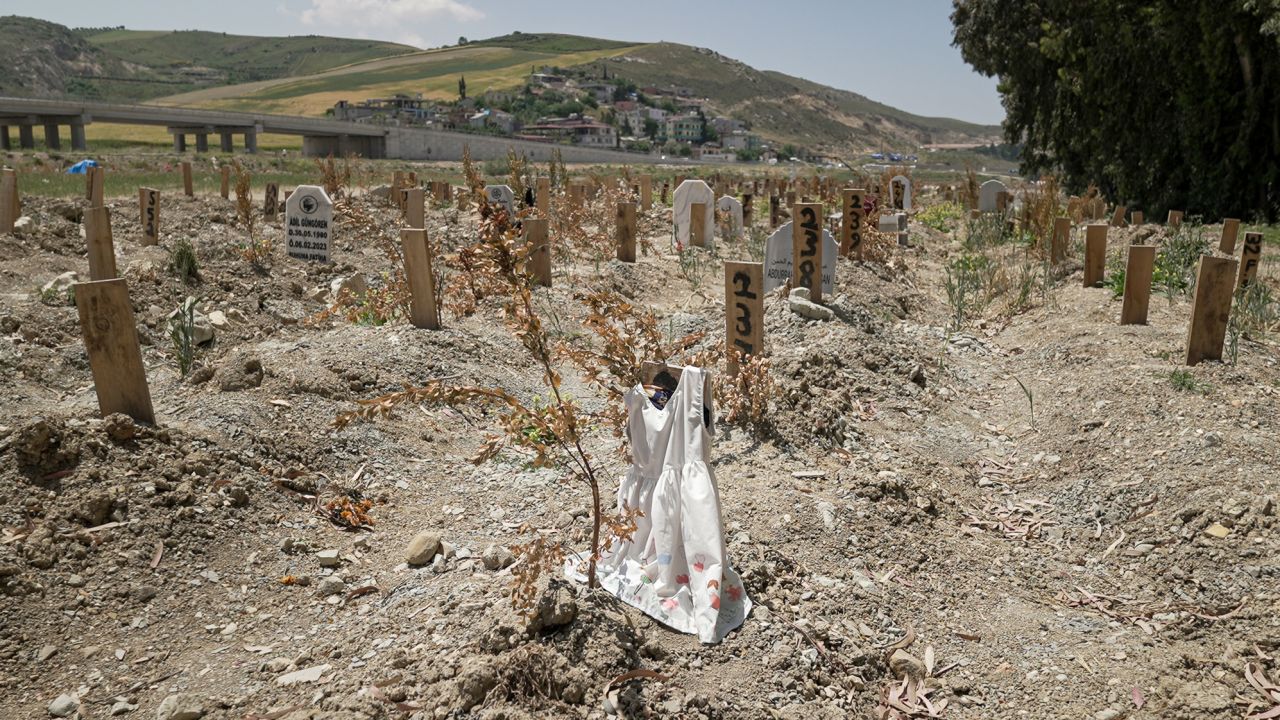 Thousands of people are still unaccounted for from Turkey's earthquake. Sometimes gravediggers will place belongings of the deceased on an unmarked grave to provide a clue for loved ones searching for them. In Narlıca cemetery, the wooden plank on grave number 236 is draped with a child's white dress. 