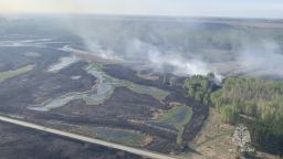 A view from a helicopter shows smoke rising from a wildfire in the Kurgan Region, Russia, in this still image taken from video released May 8, 2023. Russian Emergencies Ministry/Handout via REUTERS ATTENTION EDITORS - THIS IMAGE WAS PROVIDED BY A THIRD PARTY. NO RESALES. NO ARCHIVES. MANDATORY CREDIT.
