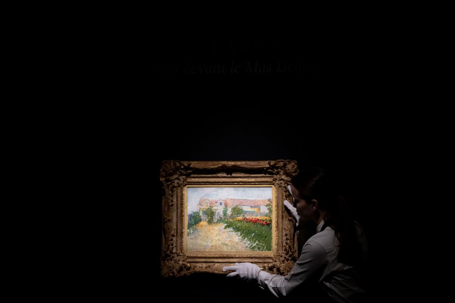 An art handler holds Vincent van Gogh's "Jardin devant le Mas Debray" at the Sothesby's auction house in New York City on Monday, May 8. It is expected to be auctioned next week for between $20 million-30 million.